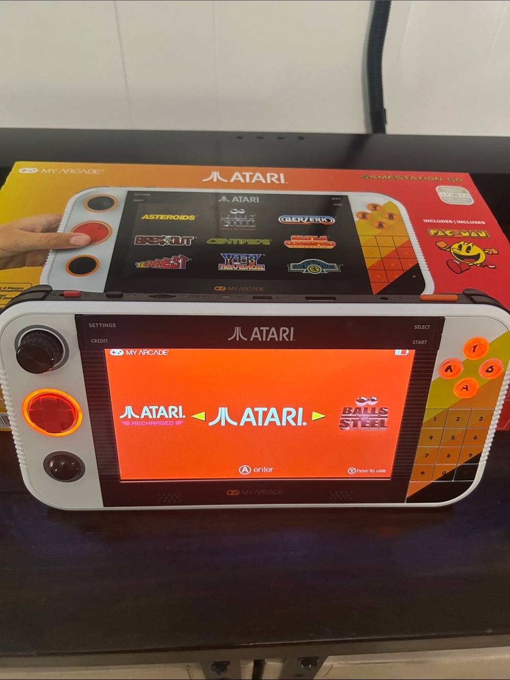 Atari Handheld Gaming Console in White and Orange